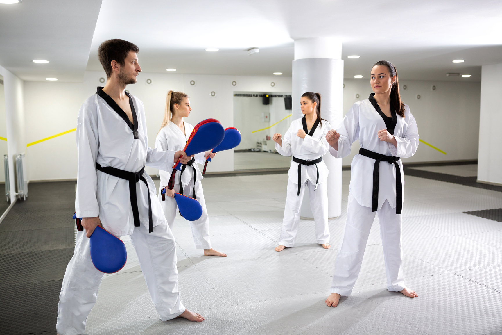 Taekwondo training with kick pad targets